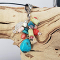 Multi-stone cluster pendant with floral design bail.