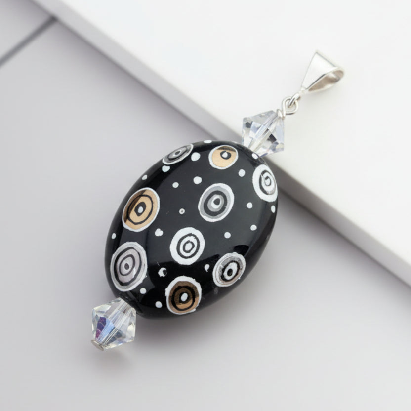 Hand-painted porcelain pendant w/ Swarovski crystals and sterling silver bail.