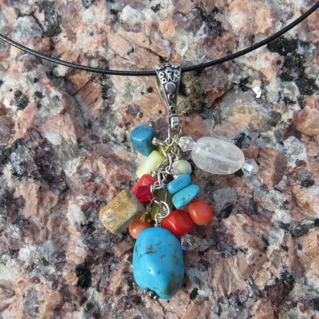 Multi-stone cluster pendant with floral design bail.